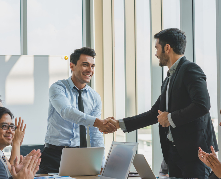 Two professionals shaking hands at end of meeting Two Professionals Shaking Hands At End Of Meeting